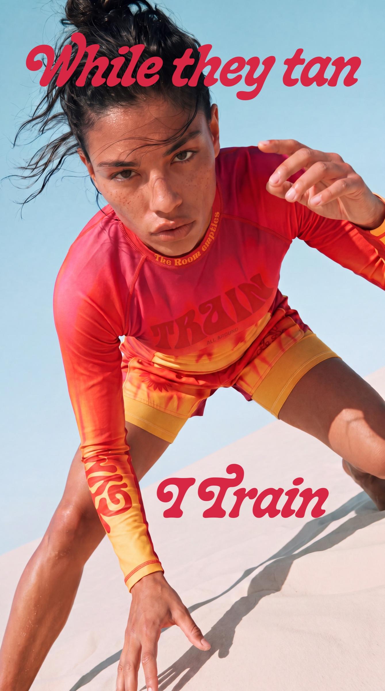 While they tan, I train — the All Around While They Tan no-gi kit in heat-haze magenta to yellow, worn low in the sand under an open sky.