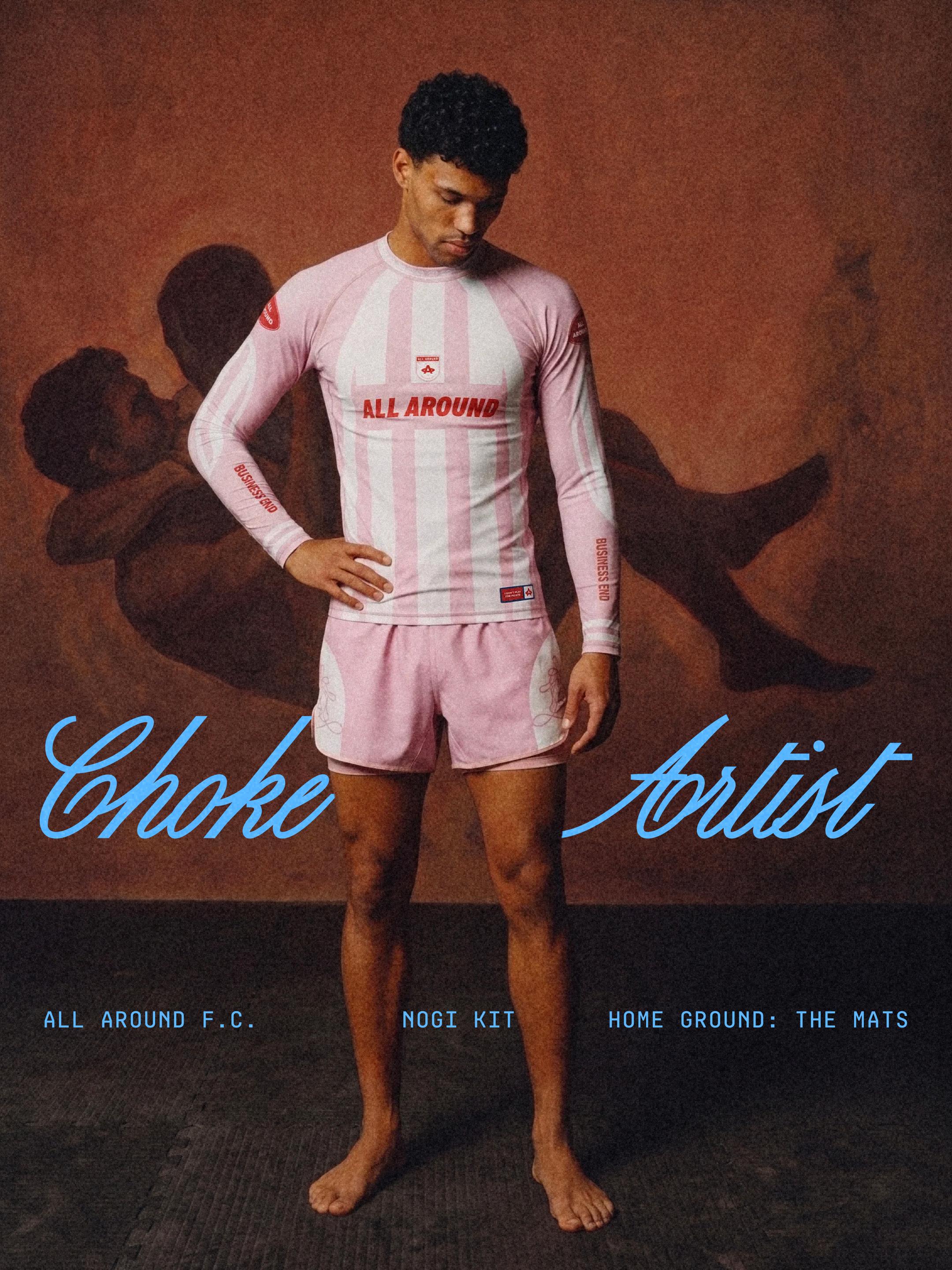 Choke Artist — the All Around F.C. no-gi kit in Rosé, on the mats against a painted choke mural.